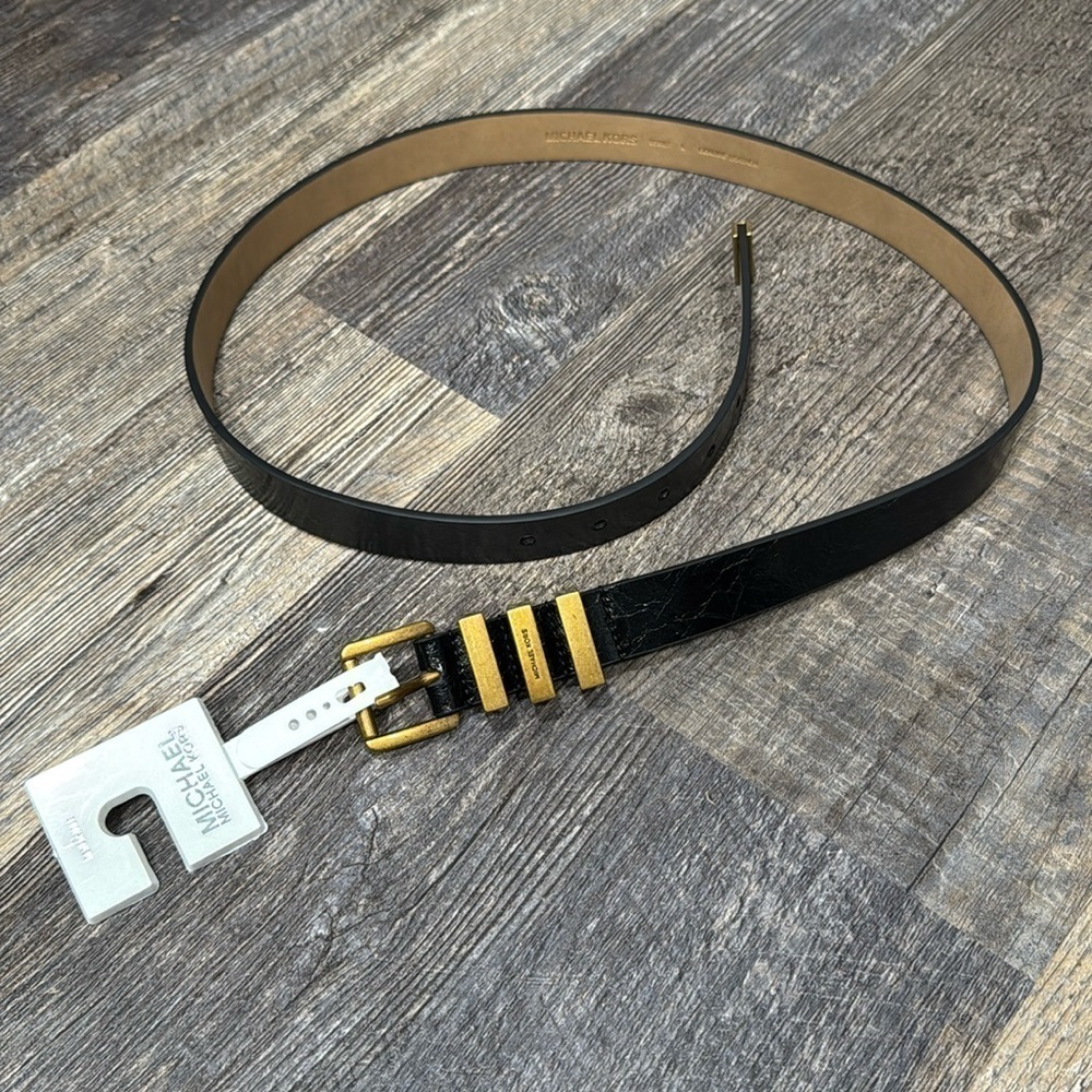 Gorgeous gold-tone hardware highlights this sleek belt from MICHAEL Michael Kors